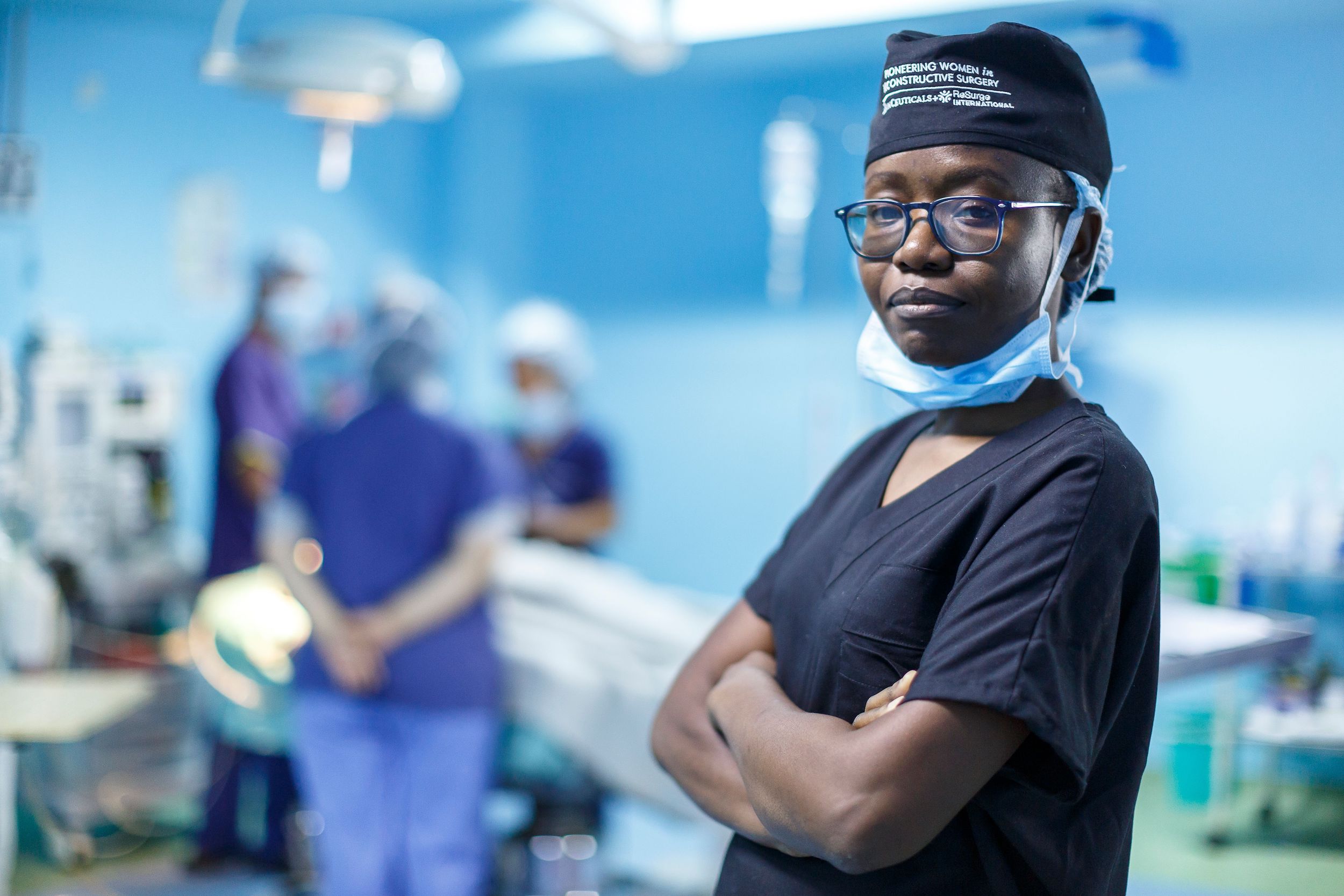 female surgeon in operating room with arms folded